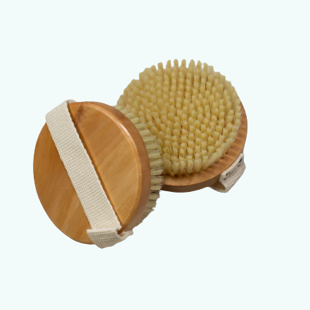 Wooden body brush with natural bristles on a white background used for exfoliation