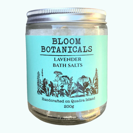 ll-natural, Canadian-made lavender bath salts by Bloom Botanicals in a clear glass jar with metal lid.